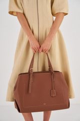 Profile view of model wearing the Oroton Margot Baby Bag & Mat in Whiskey and Pebble leather for Women