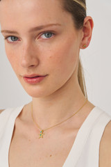 Profile view of model wearing the Oroton Starfish Necklace And Stud Set in Worn Gold/Turquoise and Brass base metal with precious metal plating for Women
