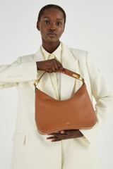 Profile view of model wearing the Oroton North Hobo in Brandy and Smooth Leather for Women