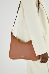 Profile view of model wearing the Oroton North Hobo in Brandy and Smooth Leather for Women