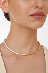 Profile view of model wearing the Oroton Valentina Necklace in Gold/White and Brass Base With 18CT Gold Plating for Women