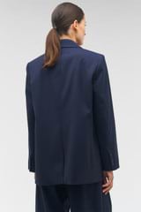 Profile view of model wearing the Oroton Single Breasted Blazer in North Sea and 98%  wool, 2% elastane for Women
