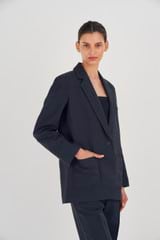 Profile view of model wearing the Oroton Single Breasted Blazer in North Sea and 58% Viscose, 42% Linen for Women