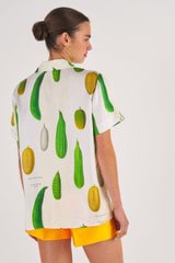 Profile view of model wearing the Oroton Summer Vegetable Camp Shirt in String and 100% Silk for Women