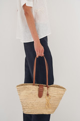 Profile view of model wearing the Oroton Madison Medium Tote in Natural/Brandy and Straw/Smooth Leather Trims for Women
