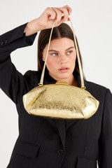 Profile view of model wearing the Oroton Meadow Metallic Clutch in Gold and Metallic Crinkle Leather for Women