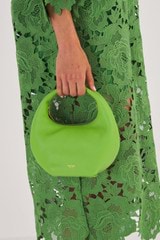 Profile view of model wearing the Oroton Tulip Mini Day Bag in Sweet Pea and Pebble Leather for Women