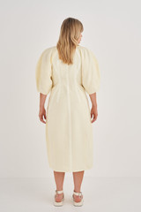 Profile view of model wearing the Oroton Structured Dress in Lemon Butter and 58% Viscose, 42% Linen for Women