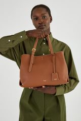Profile view of model wearing the Oroton Margot Medium Day Bag in Whiskey and Pebble Leather for Women