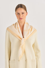 Profile view of model wearing the Oroton Polly Scarf in Oatmeal and Printed Polyester for Women