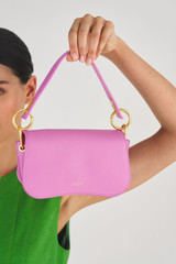 Profile view of model wearing the Oroton Liv Small Day Bag in Fuchsia and Small Pebble Leather for Women