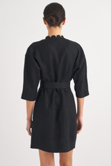 Profile view of model wearing the Oroton Short Scallop Dress in Black and 100% Linen for Women