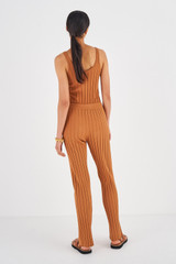 Profile view of model wearing the Oroton Rib Flare Pant in Toffee and 77% Viscose 23% Polyester for Women