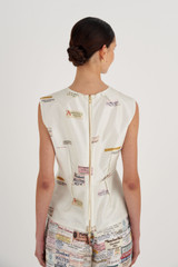 Profile view of model wearing the Oroton Spaced Label Shell Top in Soft Cream and 100% Silk for Women