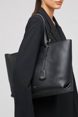 Profile view of model wearing the Oroton Margot Medium Zip Tote in Black and Pebble leather for Women