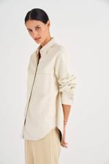 Profile view of model wearing the Oroton Leather Overshirt in Paper White and 100% Leather for Women