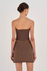 Profile view of model wearing the Oroton Short Knit Skirt in Cocoa and 100% Cotton for Women