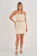 Profile view of model wearing the Oroton Short Knit Skirt in Vanilla Bean and 100% Cotton for Women