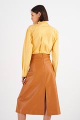Profile view of model wearing the Oroton Leather Skirt in Tan and 100% Leather for Women