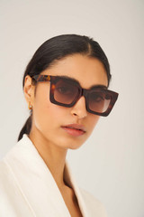 Profile view of model wearing the Oroton Reese Sunglasses in Dark Tort and Acetate for Women