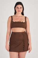 Profile view of model wearing the Oroton Scallop Wrap Skirt in Dark Chocolate and 100% Linen for Women