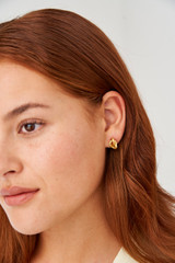 Profile view of model wearing the Oroton Luella Mini Earrings in Worn Gold and Brass Base With 18CT Gold Plating for Women