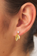 Profile view of model wearing the Oroton Sage Drop Earrings in Worn Gold and  for Women