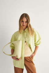 Profile view of model wearing the Oroton Long Sleeve Overshirt in Pistachio and 58% Viscose 42% Linen for Women