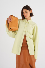 Profile view of model wearing the Oroton Long Sleeve Overshirt in Pistachio and 58% Viscose 42% Linen for Women