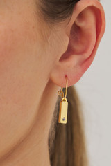 Profile view of model wearing the Oroton Zizi Hoops in Gold/Clear and  for Women