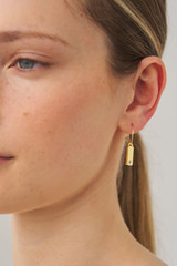 Profile view of model wearing the Oroton Zizi Hoops in Gold/Clear and  for Women