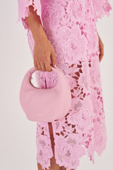 Profile view of model wearing the Oroton Tulip Mini Day Bag in Tulip Pink and Pebble Leather for Women