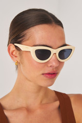 Profile view of model wearing the Oroton Lennox Sunglasses in Beach and Acetate for Women