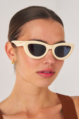 Profile view of model wearing the Oroton Lennox Sunglasses in Beach and Acetate for Women