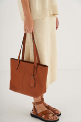Profile view of model wearing the Oroton Lilly Small Shopper Tote in Cognac and Pebble Leather for Women