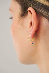 Profile view of model wearing the Oroton Starfish Charm Hoops in Worn Gold/Turquoise and Brass base metal with precious metal plating for Women