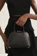 Profile view of model wearing the Oroton Muse Micro Griptop in Black and Two Tone Saffiano/Smooth Leather for Women