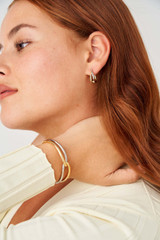 Profile view of model wearing the Oroton Nora Mini Hoops in Gold/Silver and Brass Base With Rhodium Plating for Women