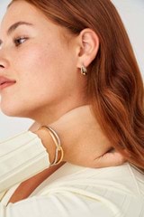 Profile view of model wearing the Oroton Nora Mini Hoops in Gold/Silver and Brass Base With Rhodium Plating for Women