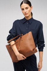 Profile view of model wearing the Oroton Margot Medium Zip Tote in Whiskey and Pebble Leather for Women