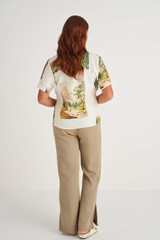 Profile view of model wearing the Oroton Split Hem Jogger in Lichen and 80% Viscose 20% Linen for Women