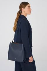 Profile view of model wearing the Oroton Margot Hobo in North Sea and Pebble Leather for Women