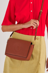 Profile view of model wearing the Oroton Polly Crossbody in Cognac and Pebble Leather for Women