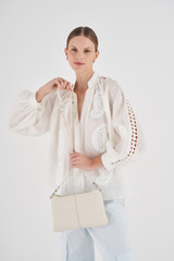 Profile view of model wearing the Oroton Tessa Crossbody in Milk and Soft Pebble Leather for Women