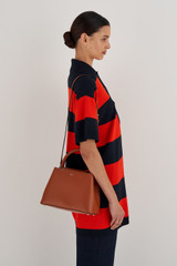 Profile view of model wearing the Oroton Muse Small Day Bag in Cognac and Saffiano / Smooth Leather for Women