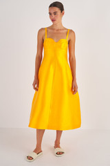 Profile view of model wearing the Oroton Sculpture Bodice Dress in Marigold and 86% Polyester, 14% Silk for Women