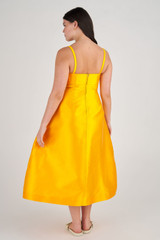 Profile view of model wearing the Oroton Sculpture Bodice Dress in Marigold and 86% Polyester, 14% Silk for Women