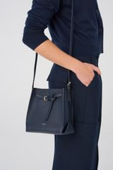 Profile view of model wearing the Oroton Margot Mini Bucket Bag in North Sea and Pebble Leather for Women