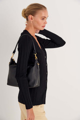 Profile view of model wearing the Oroton Lilly Zip Top Hobo in Black and Pebble leather for Women