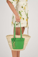 Profile view of model wearing the Oroton Maine Medium Tote in Garden/Natural and Hand Woven Straw With Recycled Leather Trims for Women